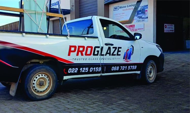 ProGlaze branded vehicle with glass rack outside the workshop