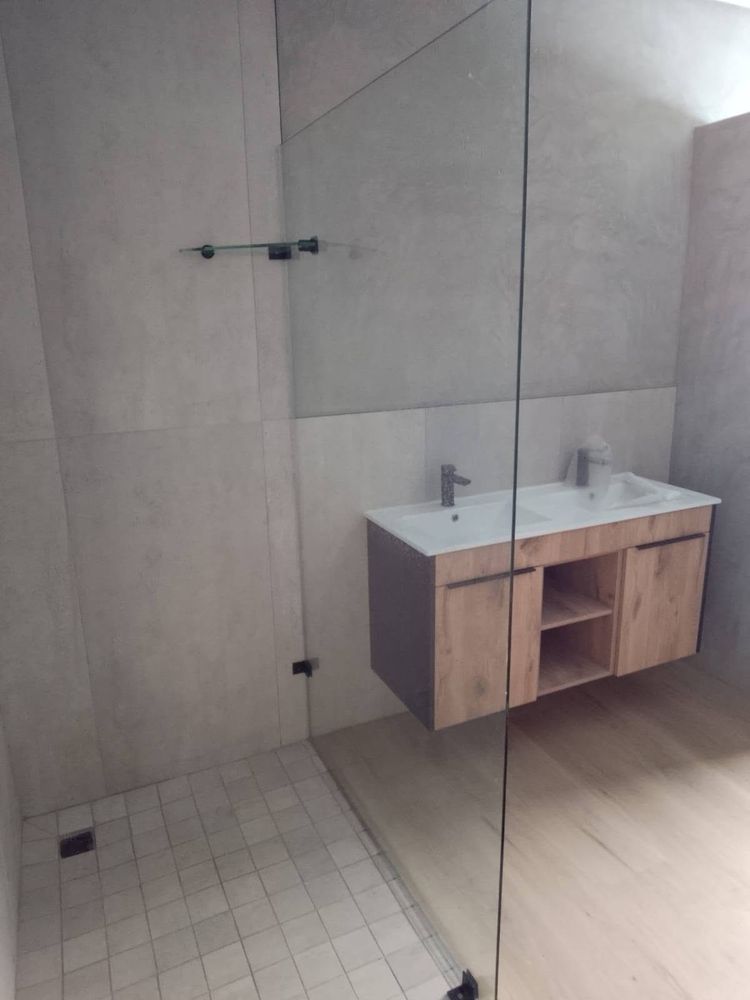 Fixed glass panel beside a floating vanity