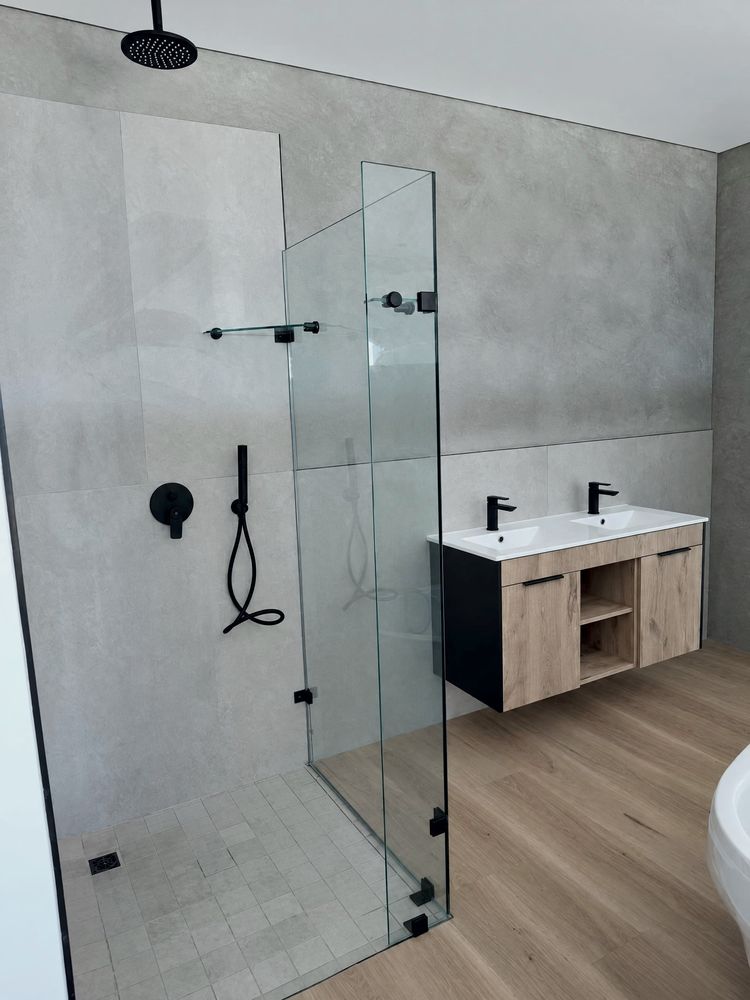 Walk-in shower beside a double vanity